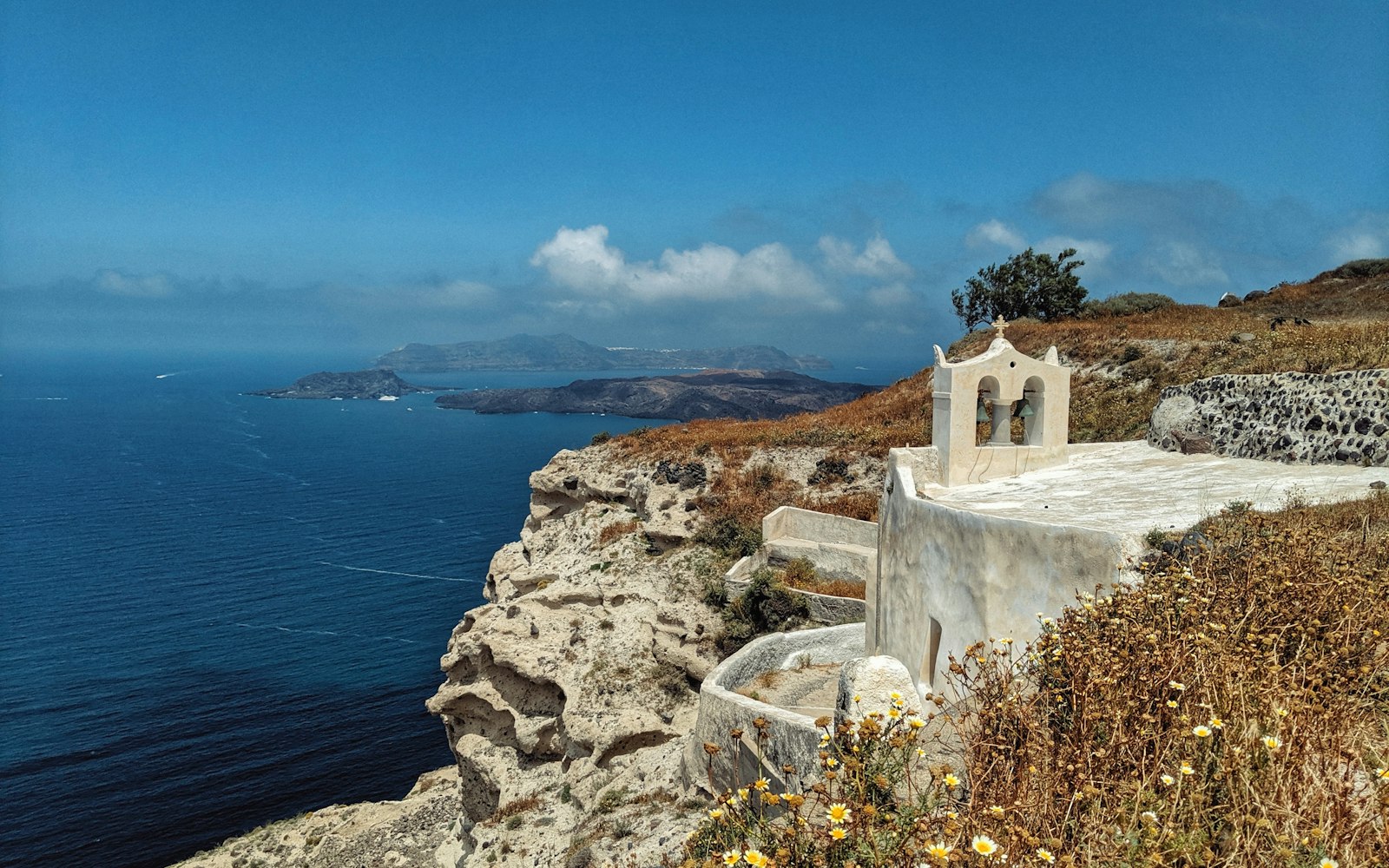 Whitewashed Santorini cliffside above the Aegean — home of Assyrtiko